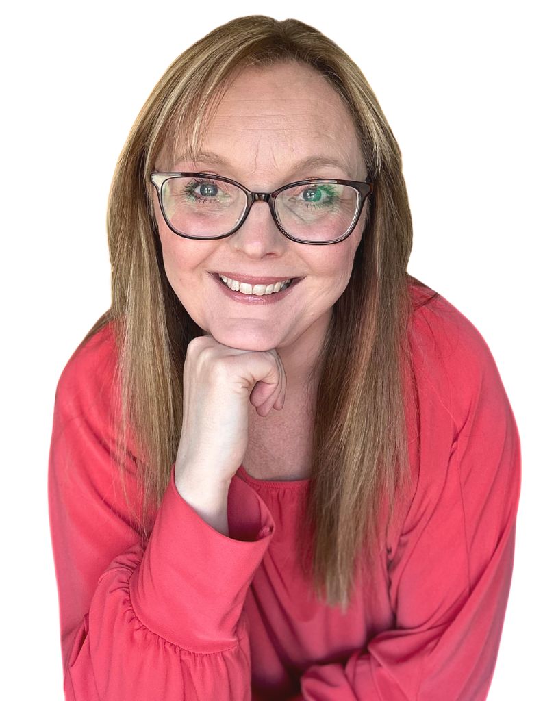 Nicola Smith Ecommerce Growth Specialist Ecommerce Consultancy Nicola Smith Ecommerce Growth Specialist Ecommerce Consultant wearing a piny ornage top, resting chin on right hand and smiling at camera
